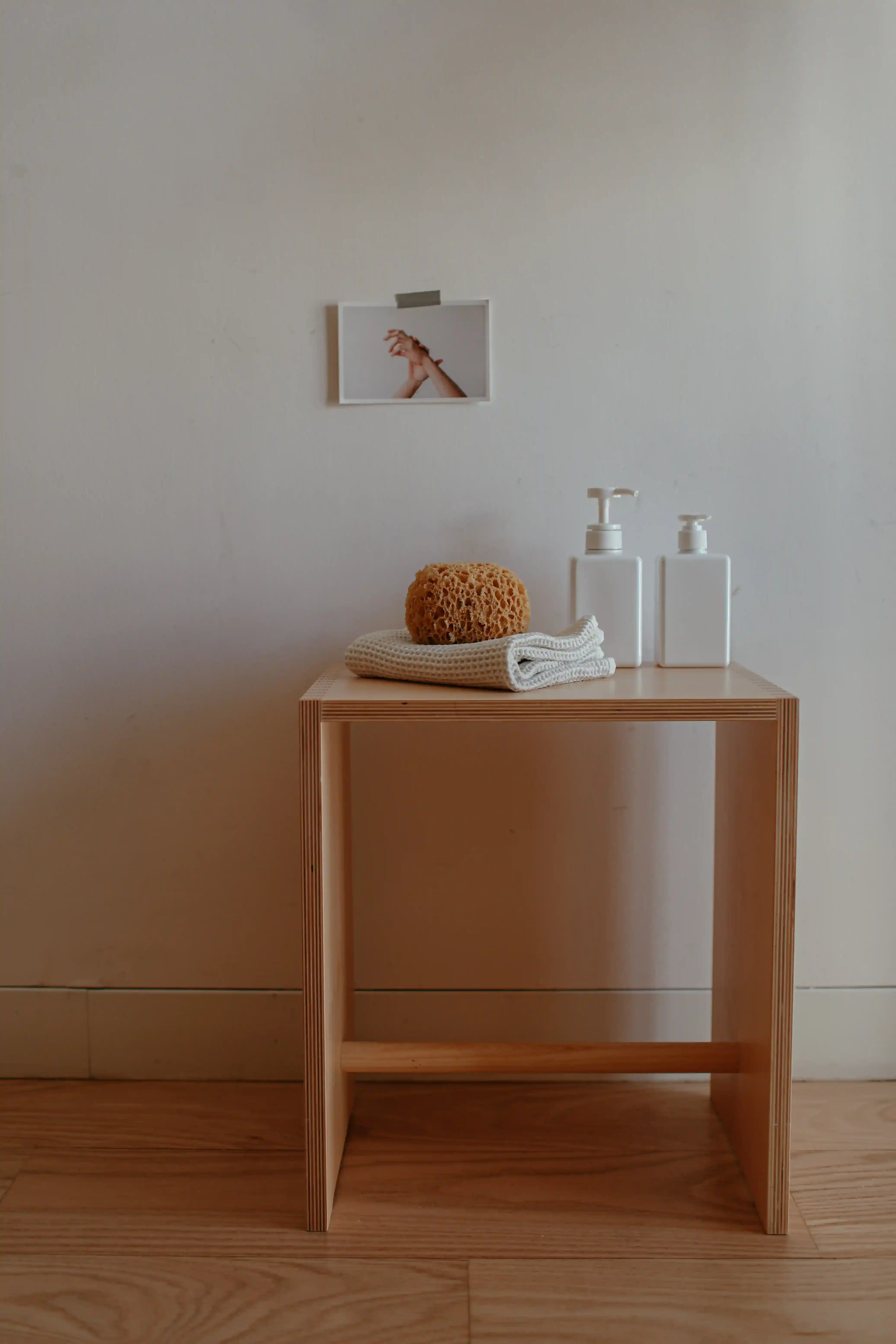 A small wooden desk with a minimalist design